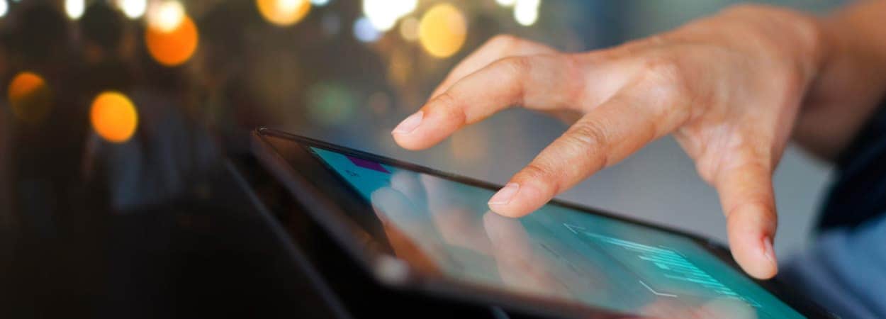 A finger tapping a tablet screen